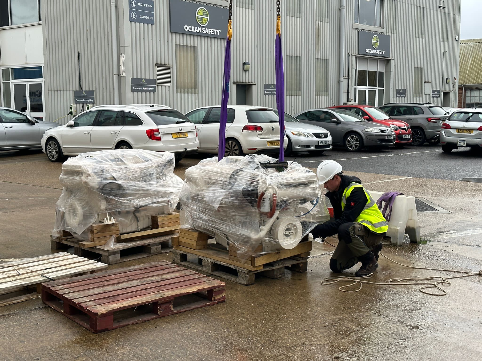 Yard worker with heavy marine parts on pallets
