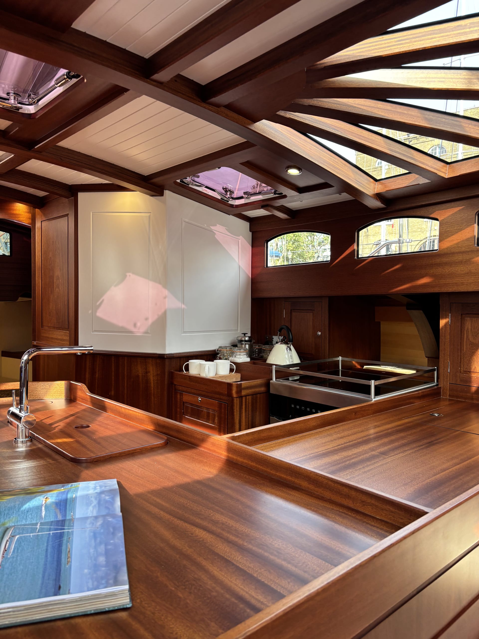 Saloon and galley of the Spirit C72 Gwenhyfar II with exposed laminated frames and deck beams